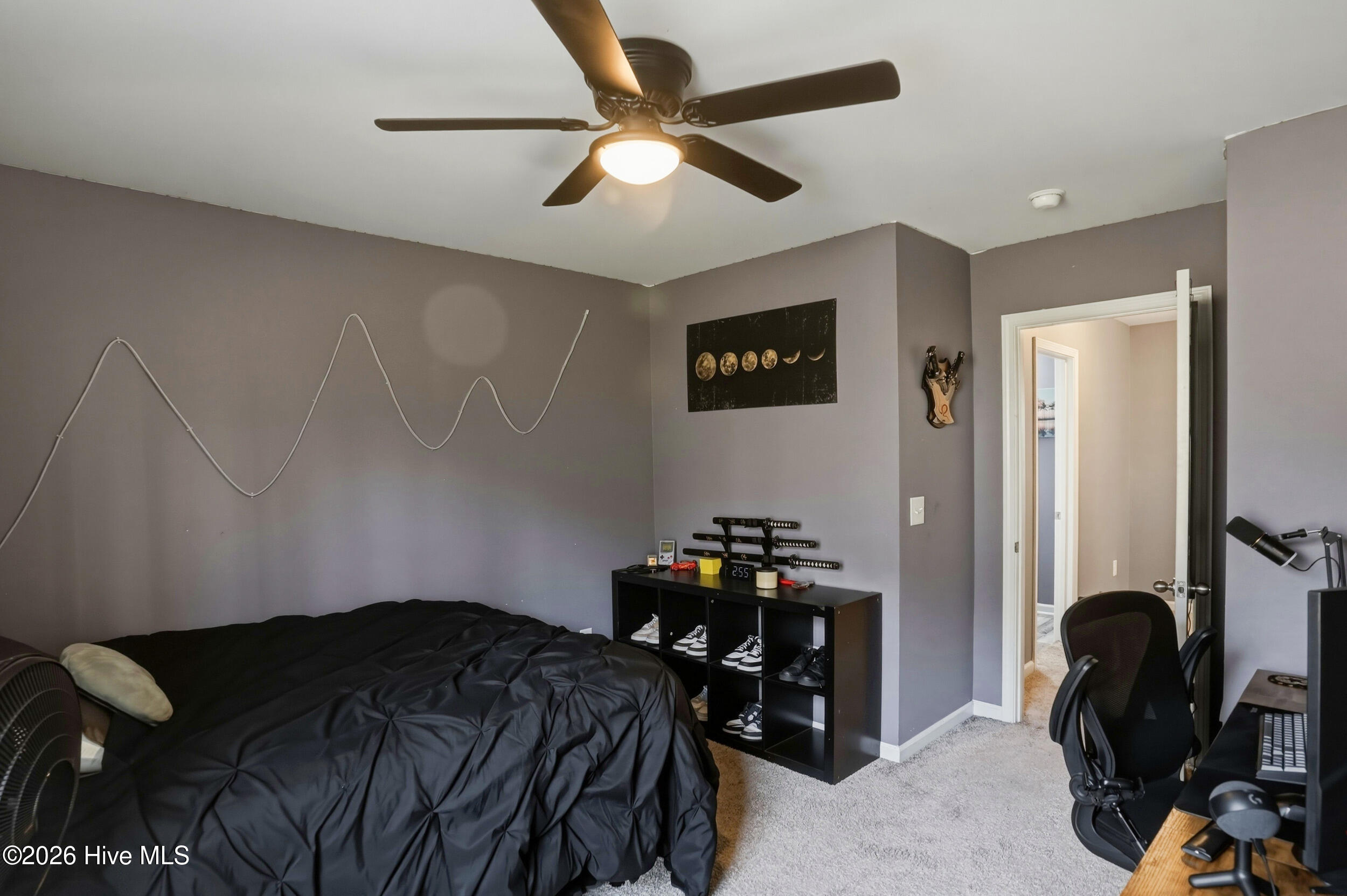 793 Landmark Cove Calabash, NC 28467 - Photo 35 of 53 Well-proportioned bedroom with abundant natural light and a ceiling fan, providing a welcoming and versatile space.