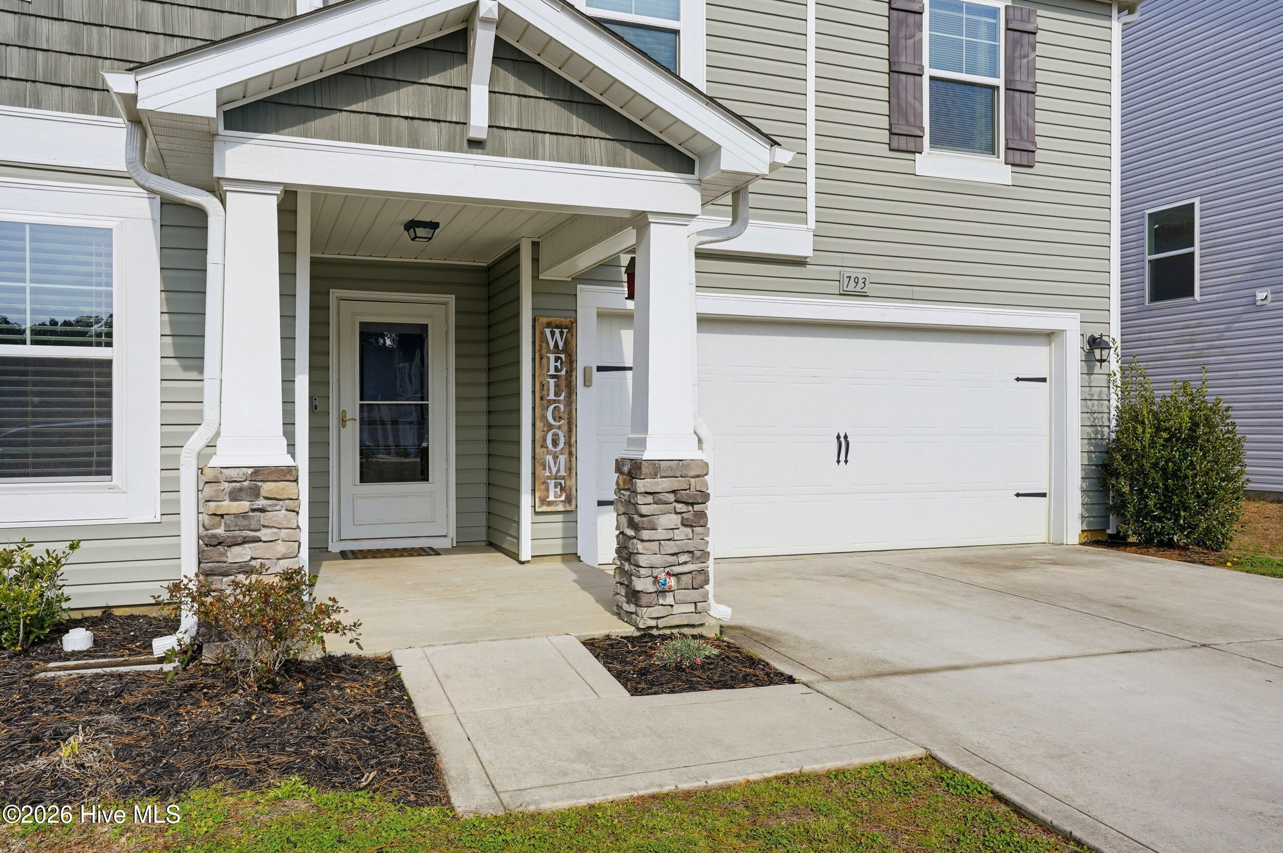 793 Landmark Cove Calabash, NC 28467 - Photo 4 of 53 Close-up of the covered front entry showcasing architectural detail and a sheltered, welcoming approach.