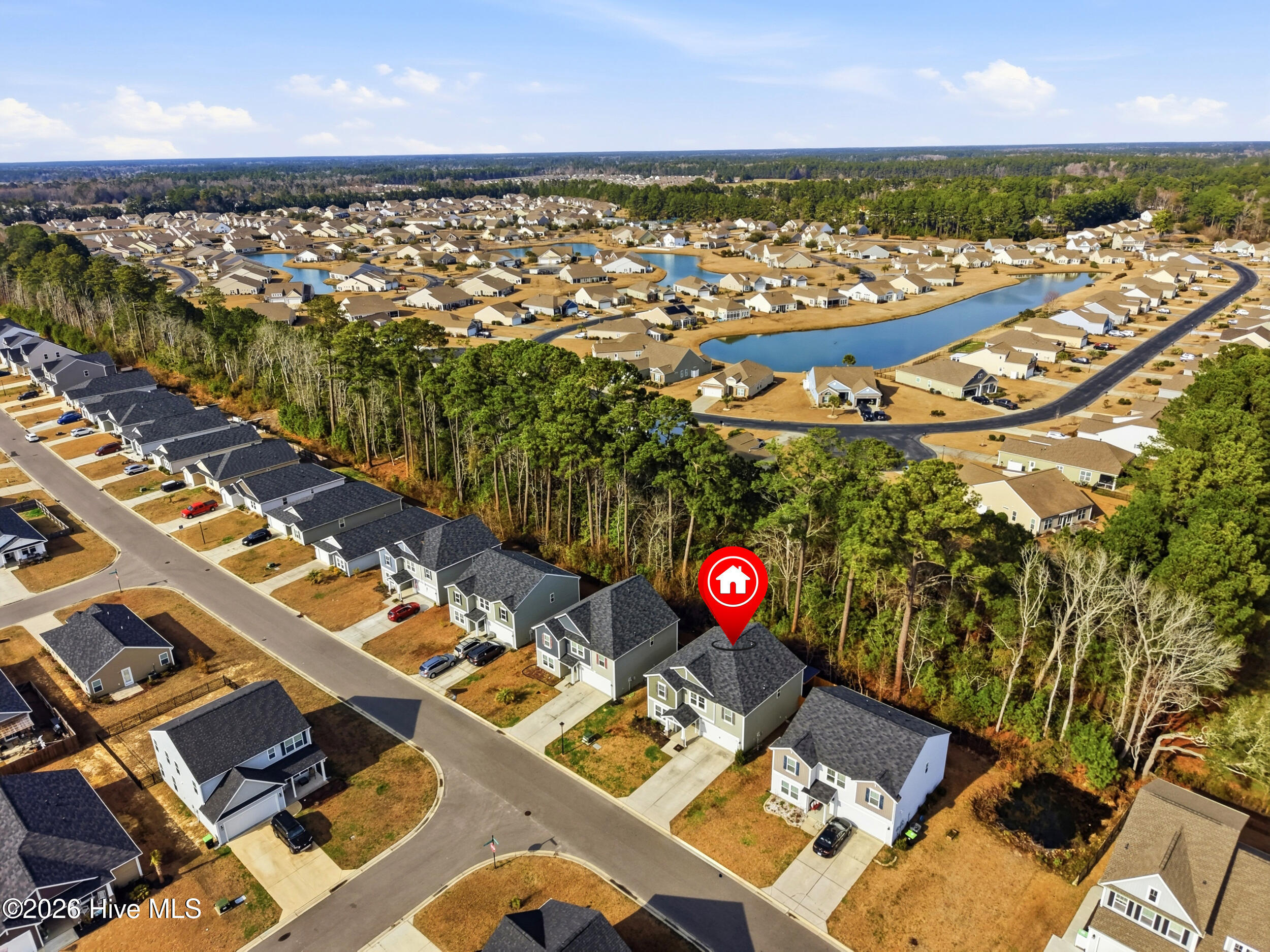 793 Landmark Cove Calabash, NC 28467 - Photo 47 of 53 Drone shot highlighting the home’s lot within the neighborhood, giving a sense of spacing, orientation, and nearby amenities.