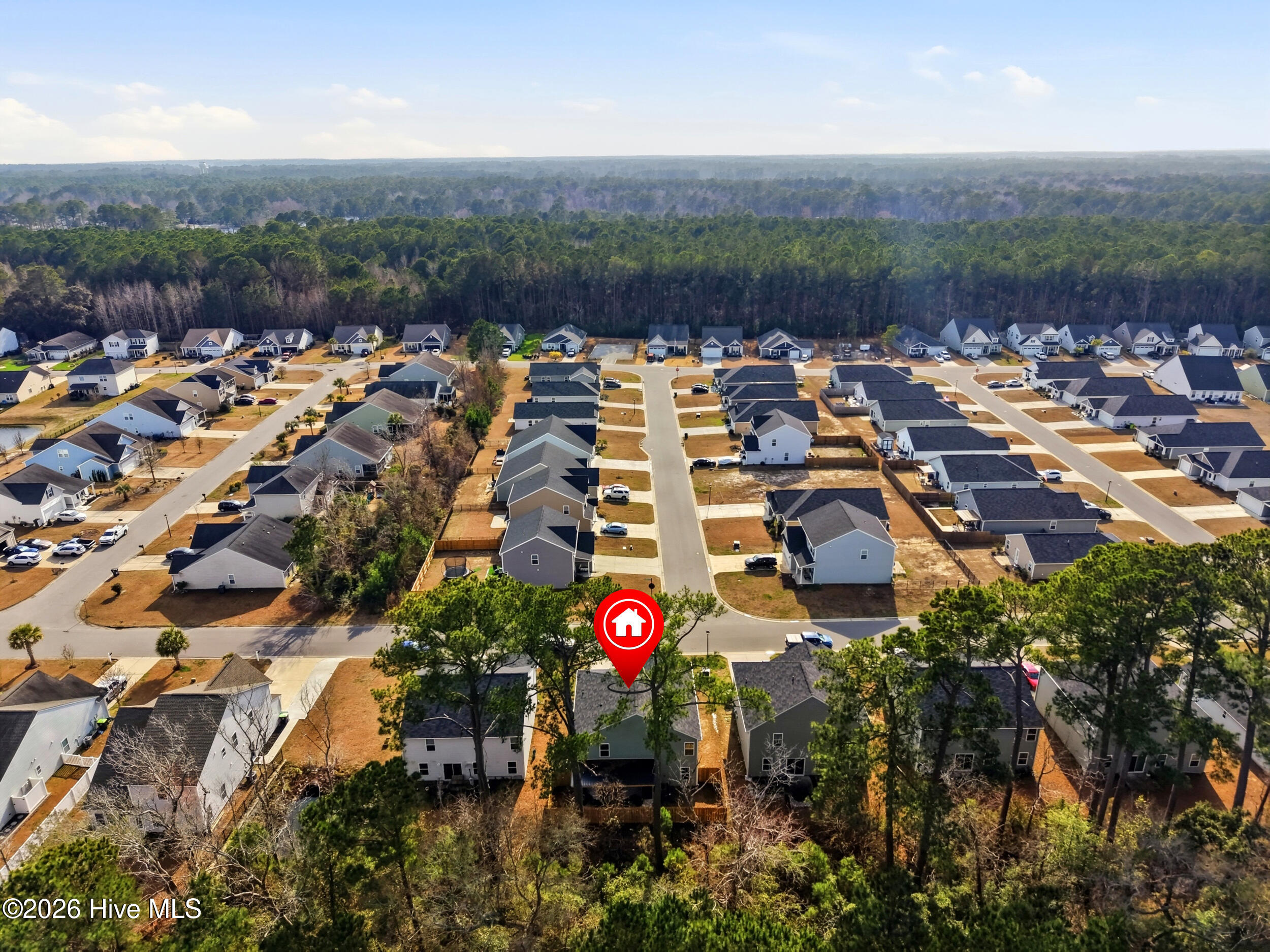 793 Landmark Cove Calabash, NC 28467 - Photo 49 of 53 Drone perspective featuring surrounding homes and green spaces, pinpointing the home’s location for clear neighborhood context.