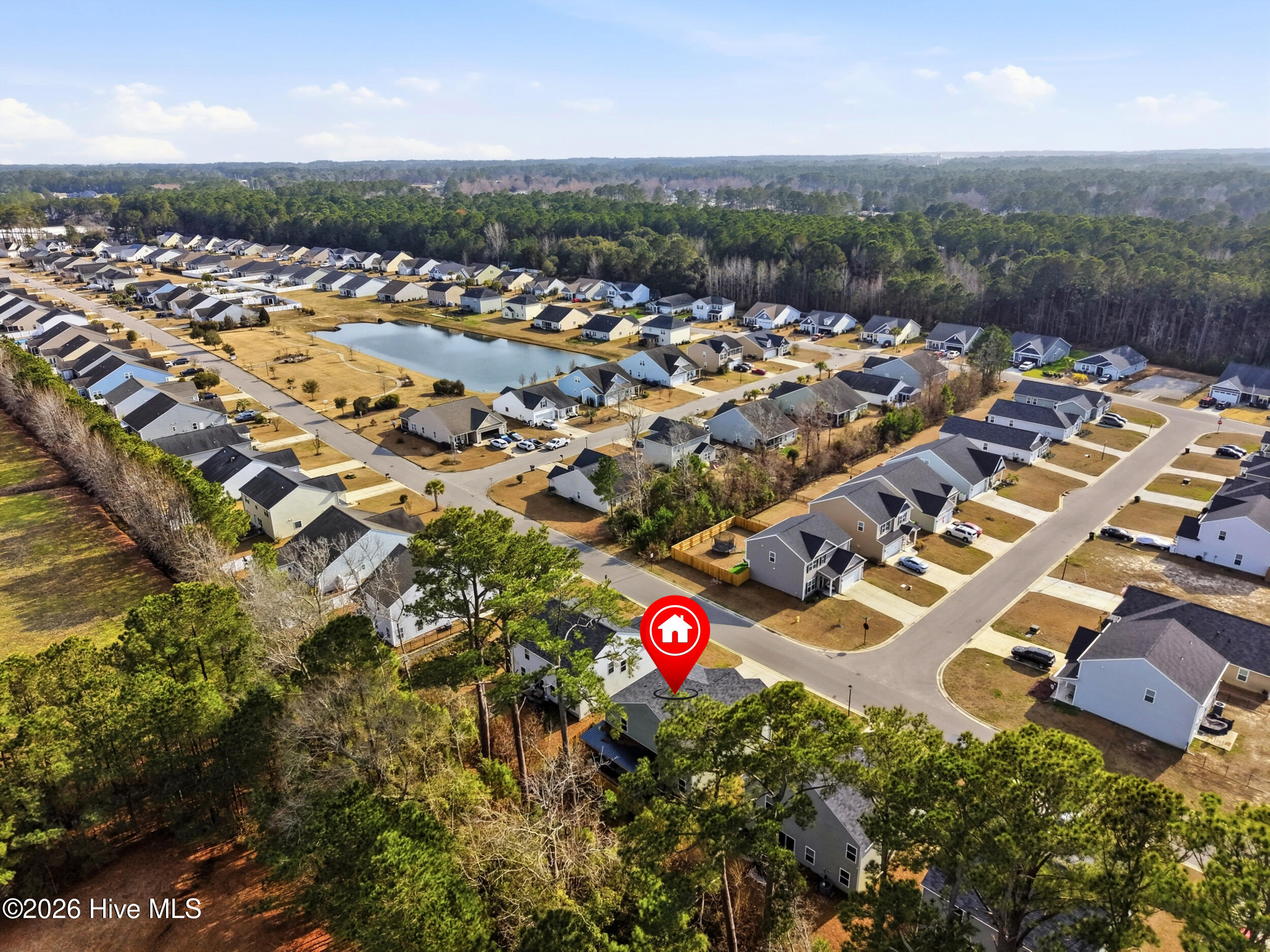 793 Landmark Cove Calabash, NC 28467 - Photo 50 of 53 Elevated aerial view highlighting the property within the neighborhood, providing buyers with a sense of orientation and community layout.