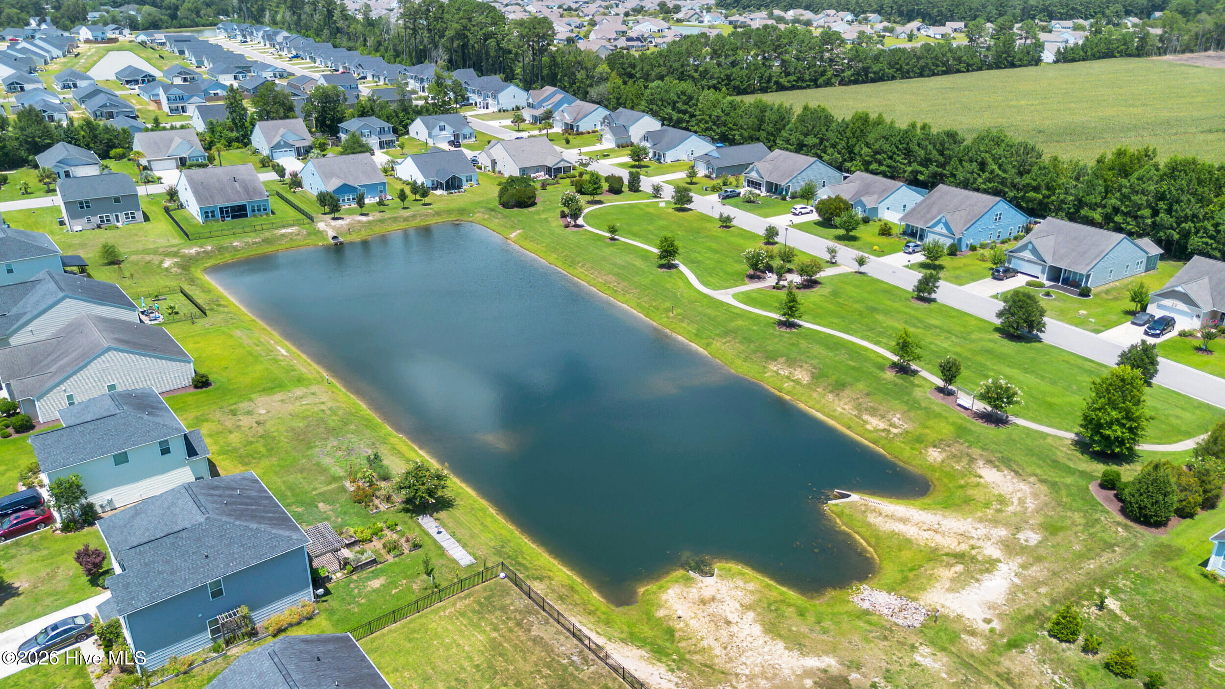 793 Landmark Cove Calabash, NC 28467 - Photo 53 of 53 View of the neighborhood pond, highlighting tranquil water features and natural surroundings that enhance the community’s appeal.