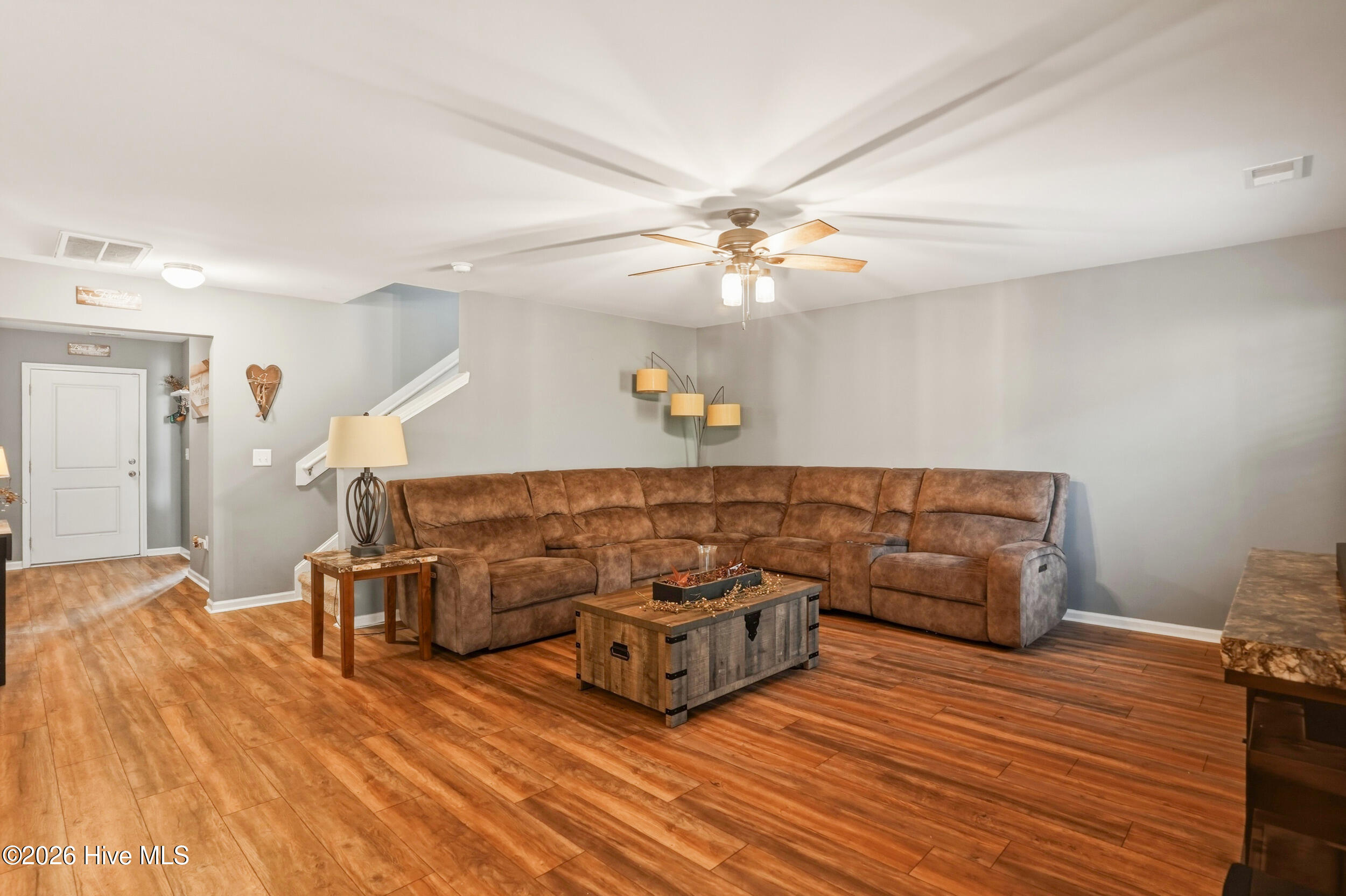 793 Landmark Cove Calabash, NC 28467 - Photo 9 of 53 Well-proportioned living area featuring durable LVP flooring and a ceiling fan for added comfort, designed for everyday living and effortless entertaining.