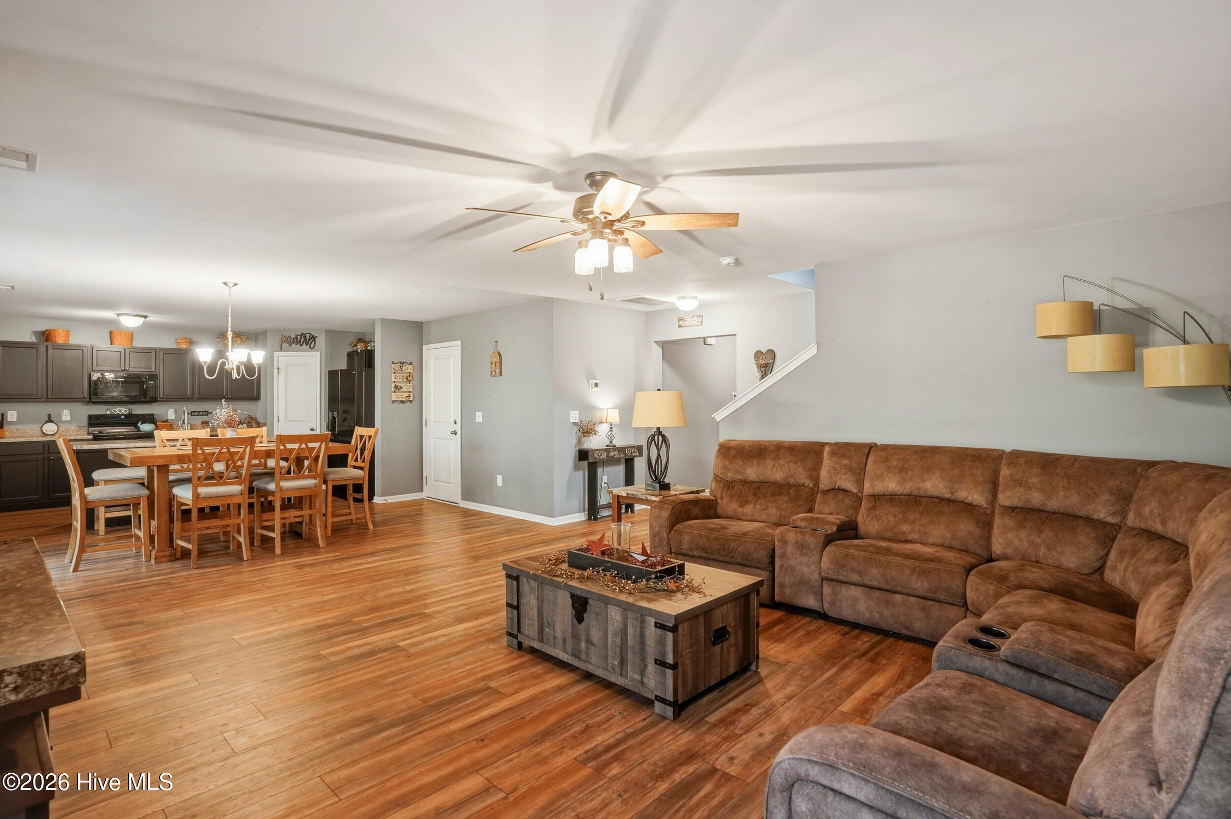 793 Landmark Cove Calabash, NC 28467 - Photo 10 of 53 Seamless open-concept layout connecting the living room to the dining area and kitchen, enhanced by continuous LVP flooring and a bright, connected feel throughout the main living spaces.