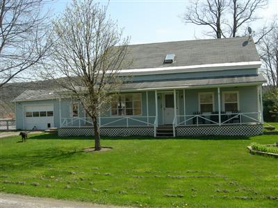 2472 County Highway Oneonta, NY 13820 - Photo 1 of 1 Front of house w/rocking chair porch.