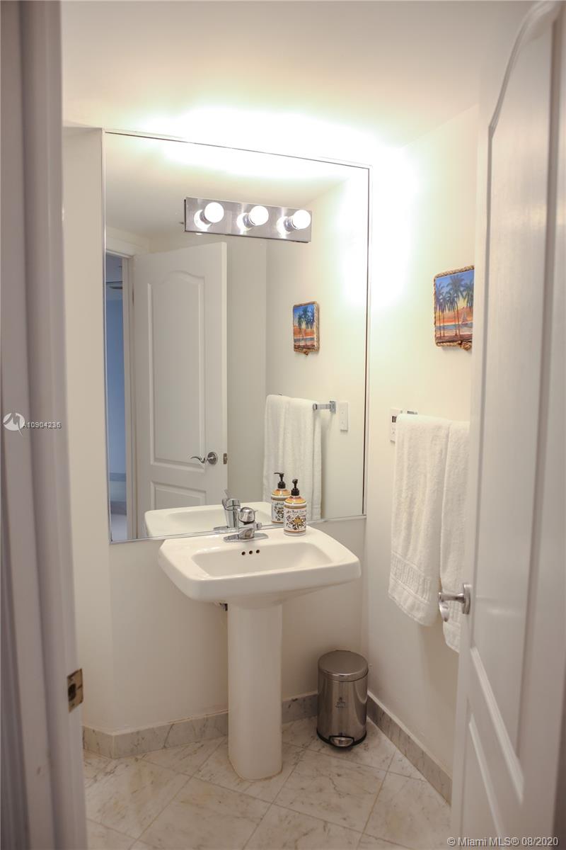 9455 Collins Avenue, Unit 707 Surfside, FL 33154 - Photo 15 of 60 a bathroom with a sink toilet and shower