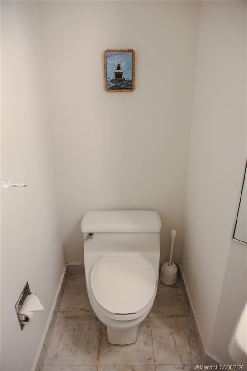 9455 Collins Avenue, Unit 707 Surfside, FL 33154 - Photo 16 of 60 a bathroom with a toilet and a vanity