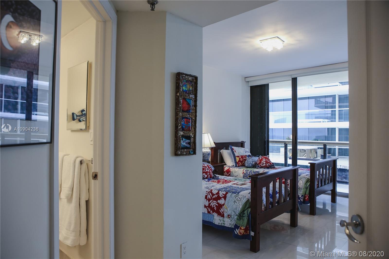 9455 Collins Avenue, Unit 707 Surfside, FL 33154 - Photo 18 of 60 a bedroom with furniture and a window