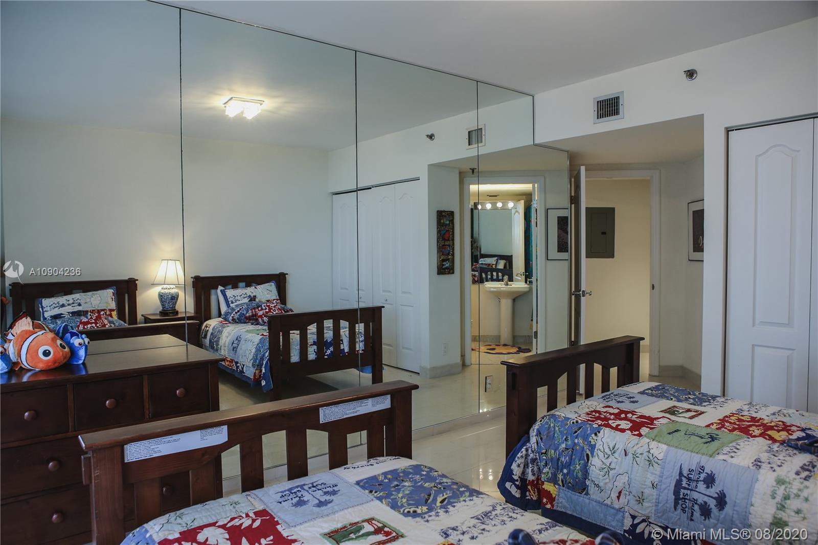 9455 Collins Avenue, Unit 707 Surfside, FL 33154 - Photo 21 of 60 a bedroom with a bed dresser and a window