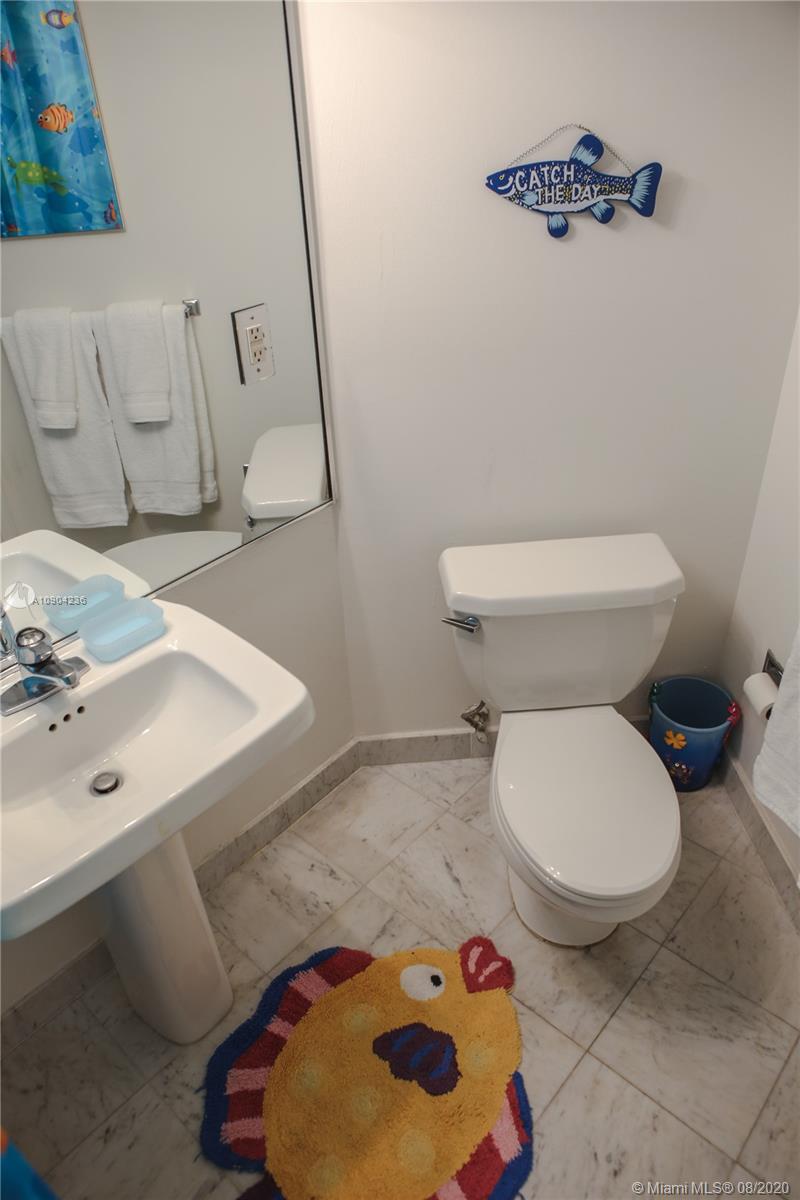 9455 Collins Avenue, Unit 707 Surfside, FL 33154 - Photo 24 of 60 a bathroom with a toilet and a sink