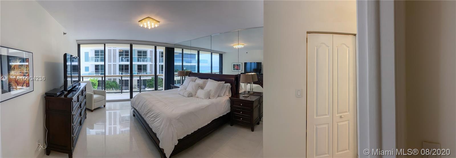 9455 Collins Avenue, Unit 707 Surfside, FL 33154 - Photo 25 of 60 a bed room with a bed and a large window