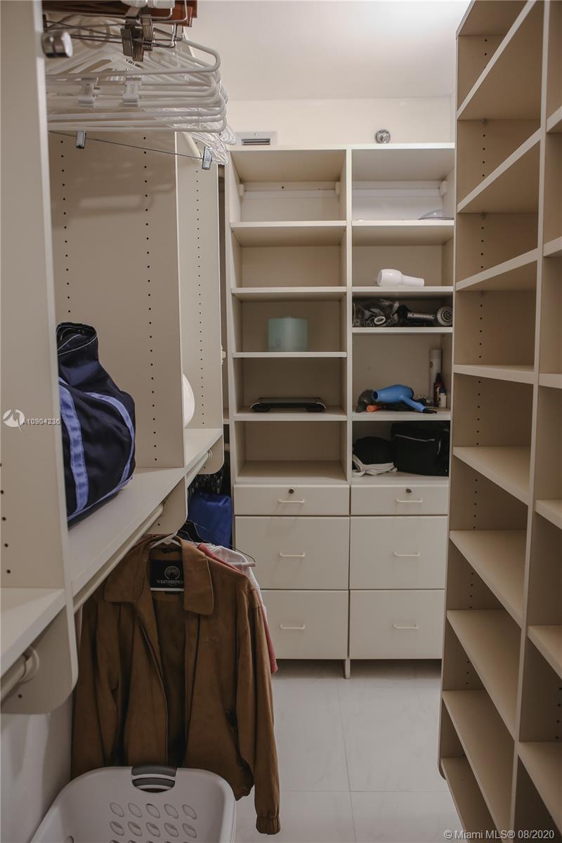 9455 Collins Avenue, Unit 707 Surfside, FL 33154 - Photo 28 of 60 a view of walk in closet with empty racks