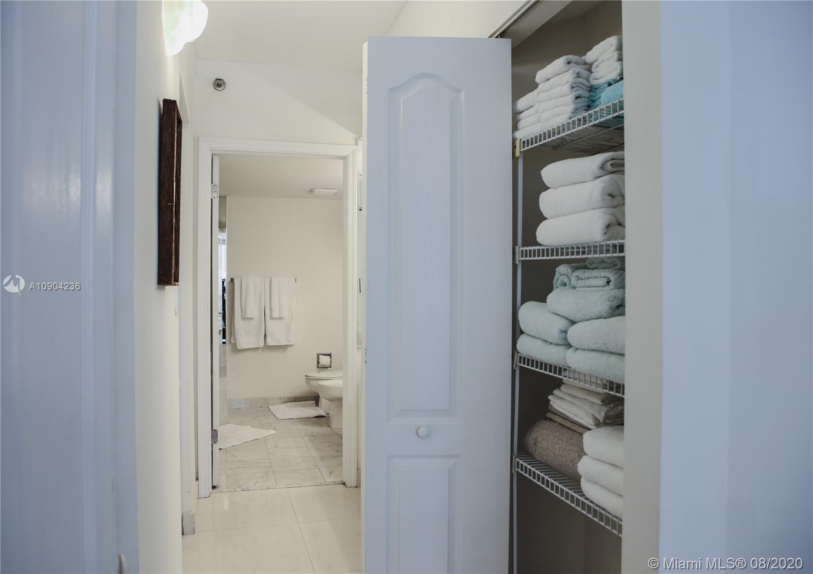 9455 Collins Avenue, Unit 707 Surfside, FL 33154 - Photo 29 of 60 a bathroom with a glass shower door and a sink