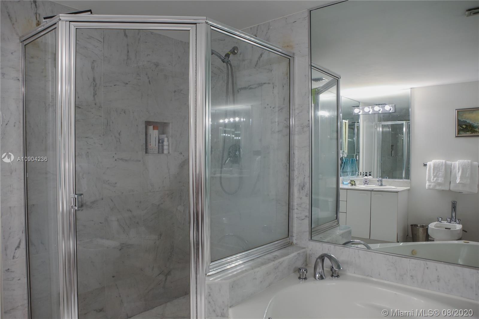 9455 Collins Avenue, Unit 707 Surfside, FL 33154 - Photo 32 of 60 a bathroom with a shower and a sink