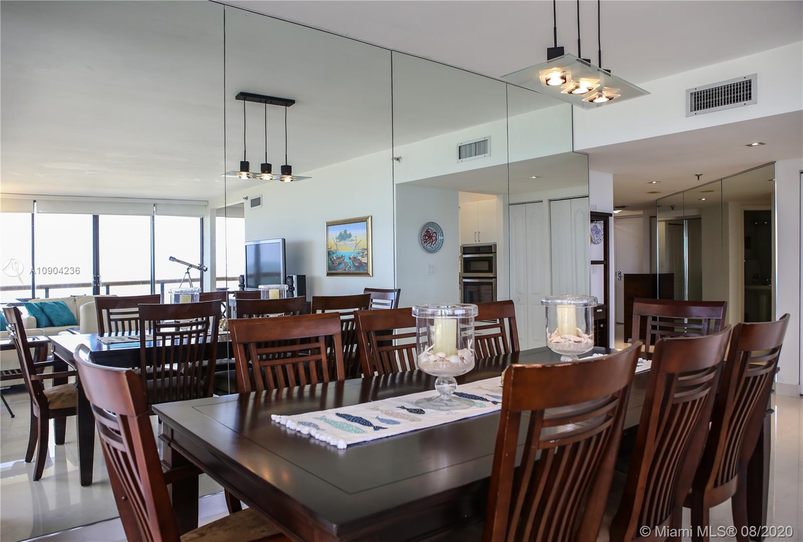 9455 Collins Avenue, Unit 707 Surfside, FL 33154 - Photo 34 of 60 a view of a dining area with furniture window and wooden floor