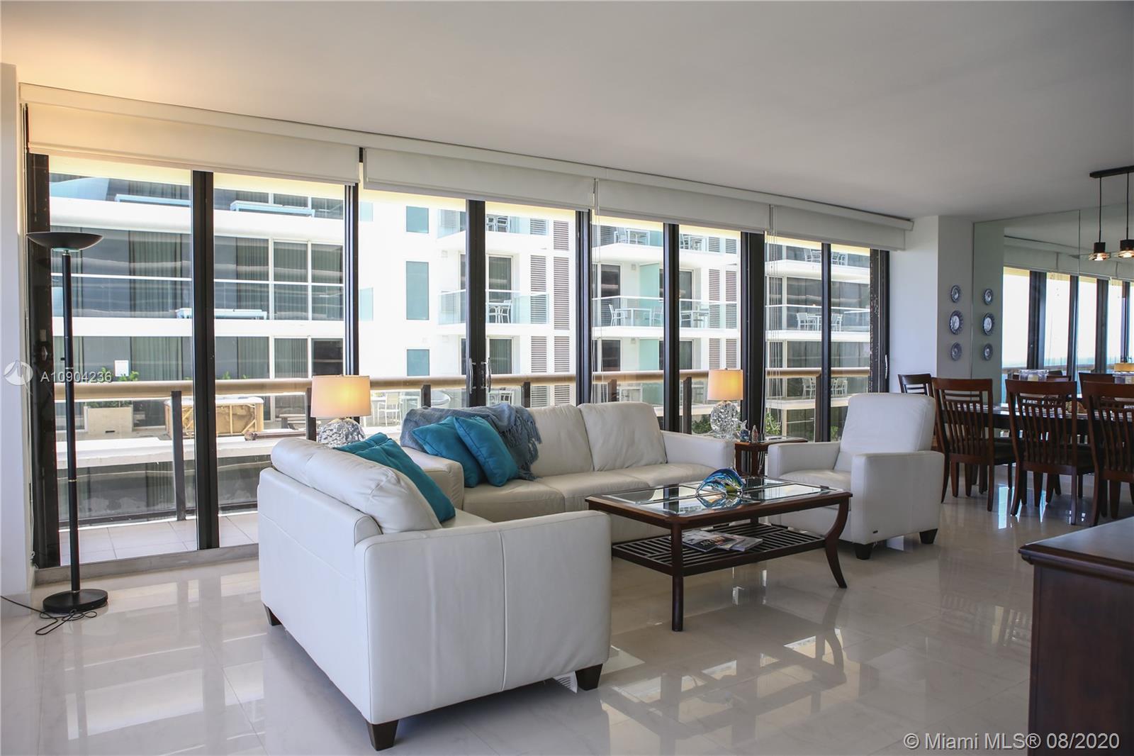 9455 Collins Avenue, Unit 707 Surfside, FL 33154 - Photo 37 of 60 a living room with furniture and a large window