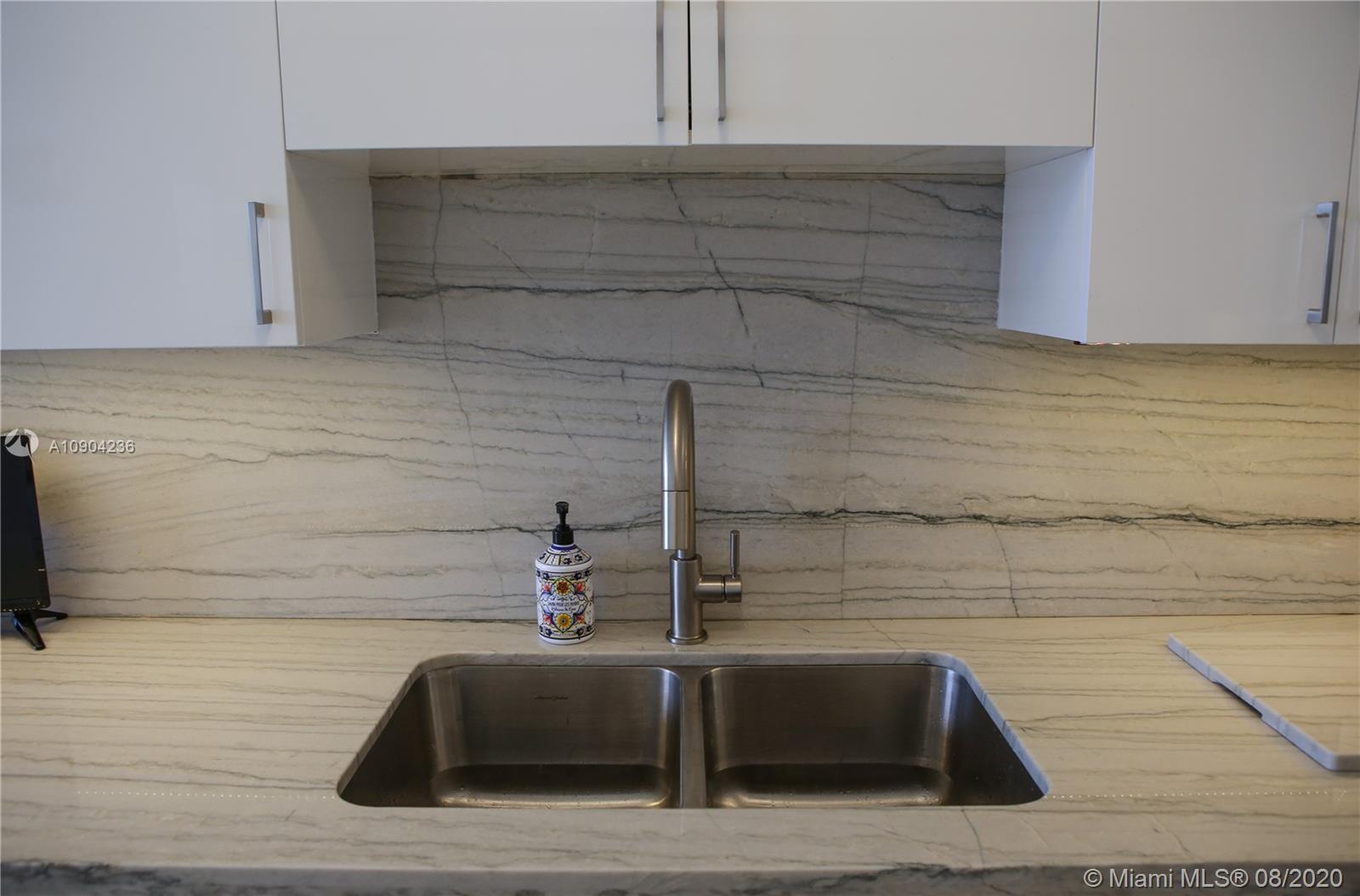 9455 Collins Avenue, Unit 707 Surfside, FL 33154 - Photo 43 of 60 a bathroom with a bathtub