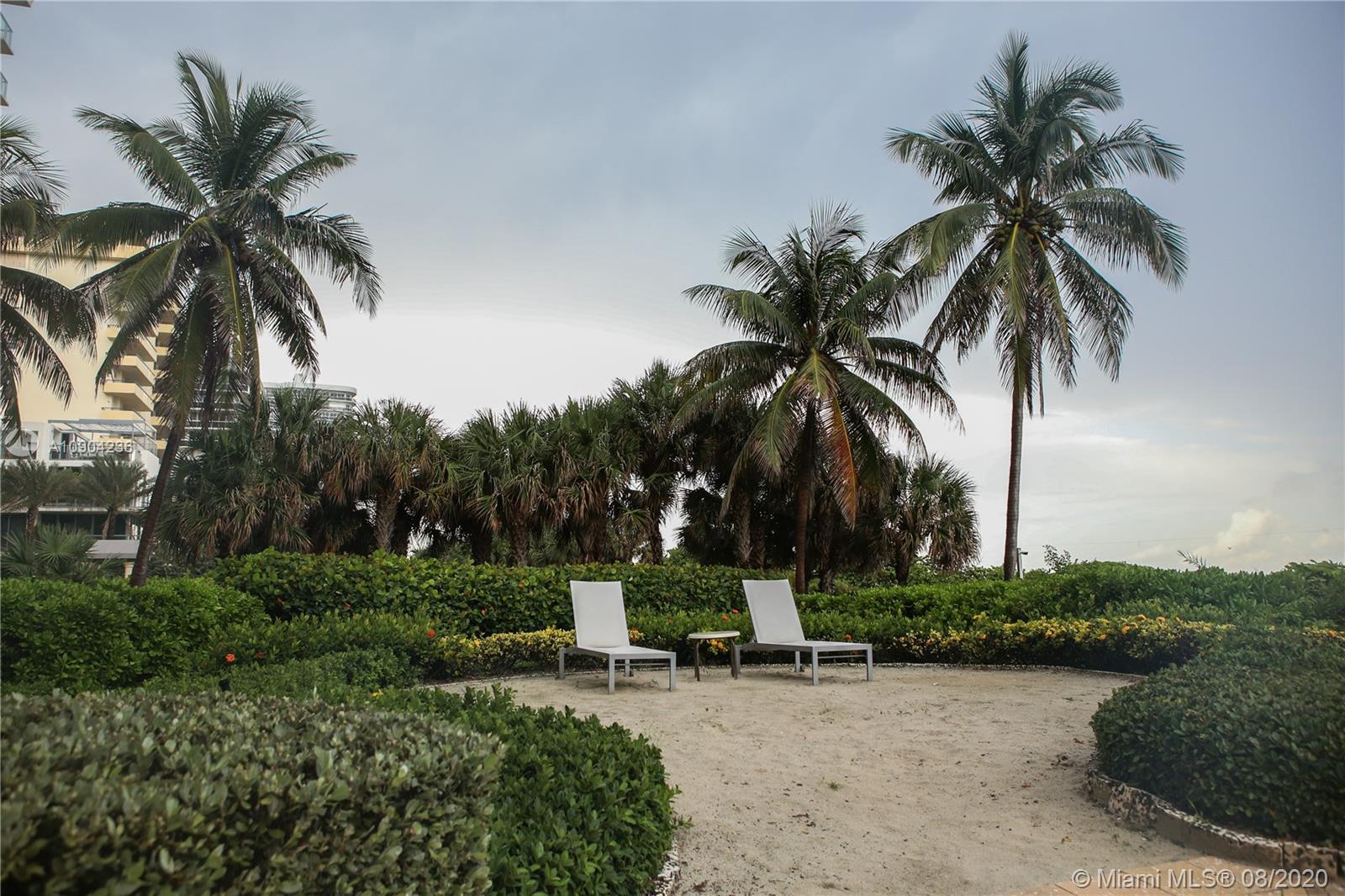 9455 Collins Avenue, Unit 707 Surfside, FL 33154 - Photo 5 of 60 a couple of palm trees sitting in a yard with swimming pool