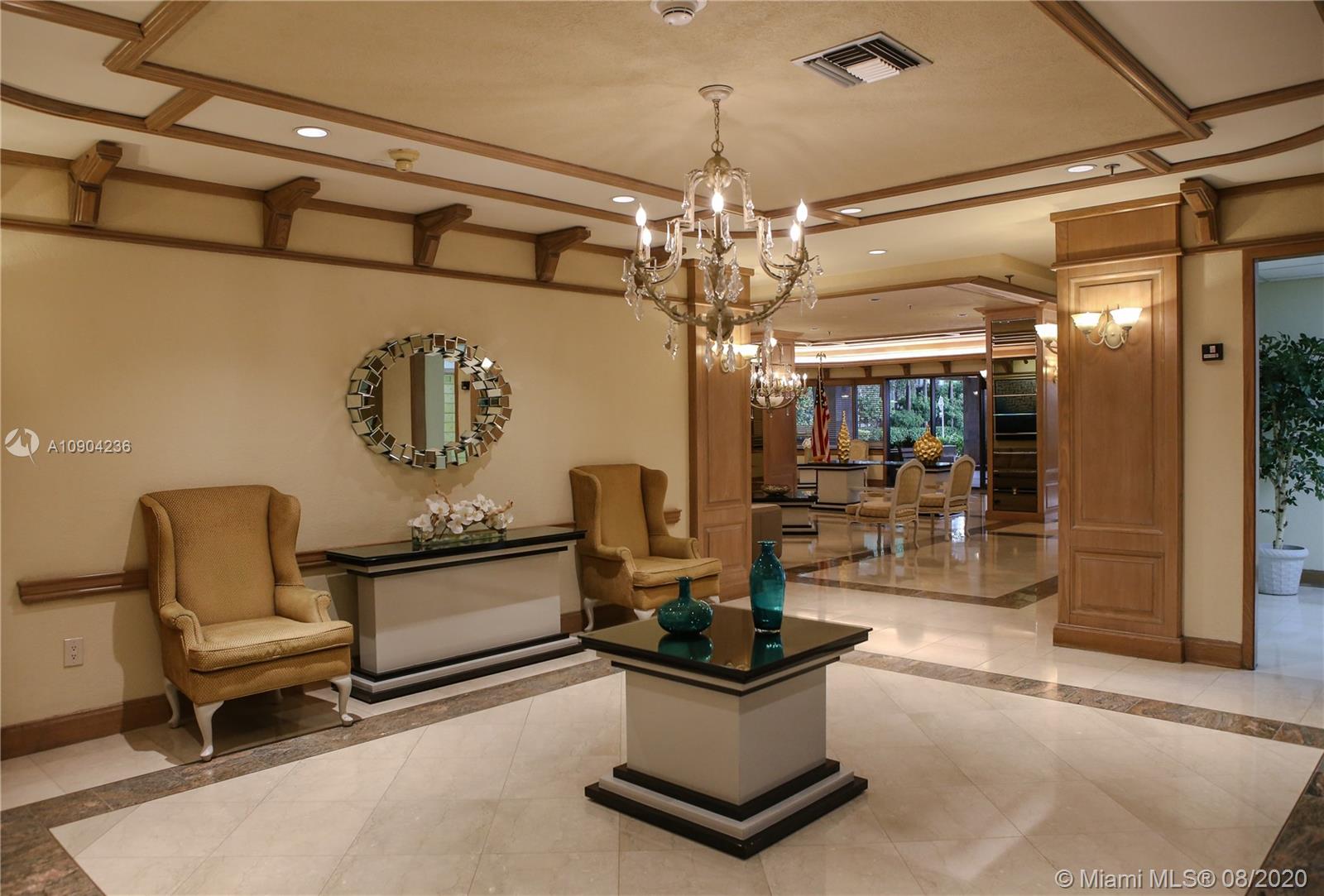 9455 Collins Avenue, Unit 707 Surfside, FL 33154 - Photo 57 of 60 a living room with patio furniture and a chandelier