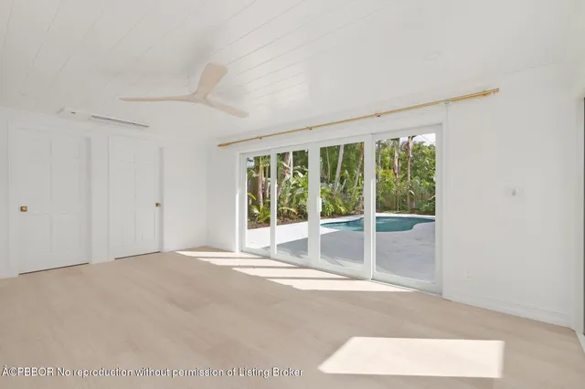 a view of an empty room with glass door