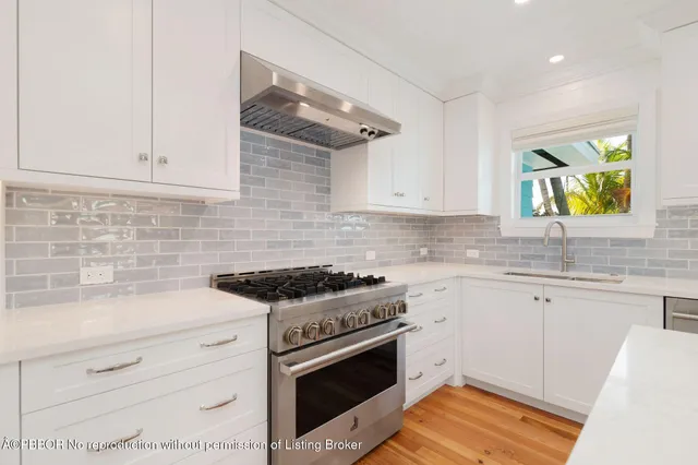 a kitchen with a sink stainless steel appliances and cabinets