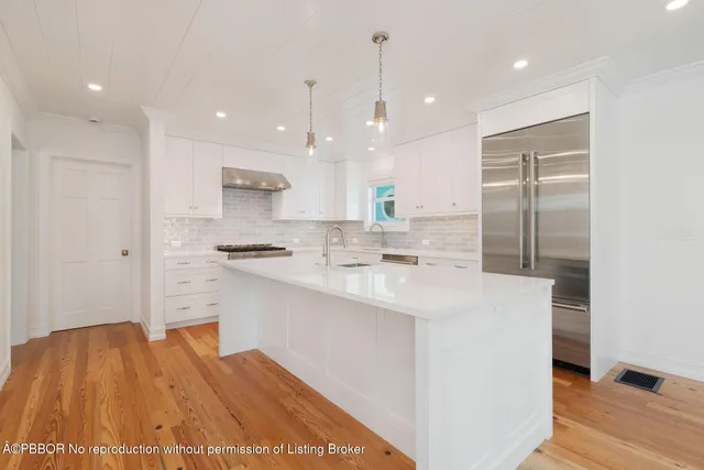 a kitchen with stainless steel appliances sink stove and cabinets