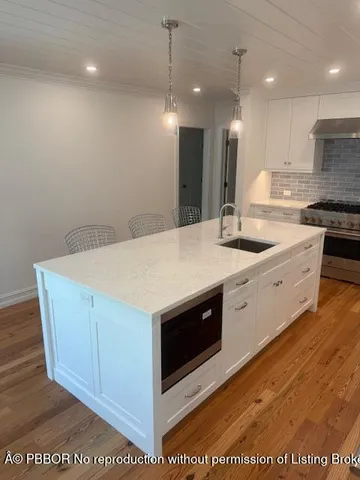 a kitchen with a sink window and cabinets