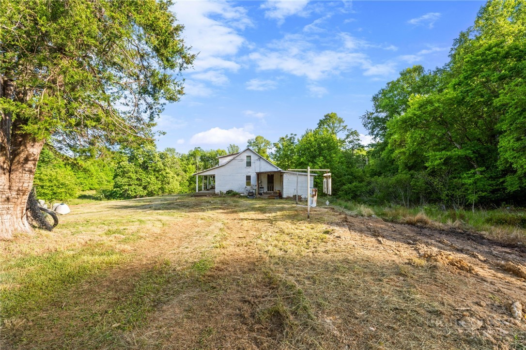 657 Lawrence Greene Road Deep Gap, NC 28618 - Photo 3 of 25 a small yard with large trees