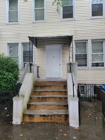 a front view of a house with a chair