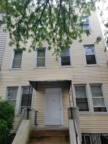a view of a house with a tree