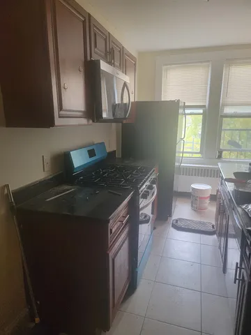 a kitchen with a stove and a refrigerator
