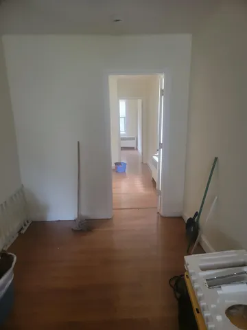 a view of a livingroom with wooden floor and stairs