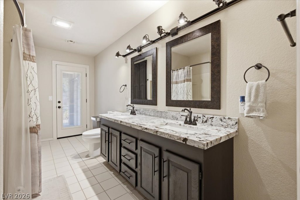 6191 South Lindell Road Las Vegas, NV 89118 - Photo 39 of 53 Full bathroom with tub/shower combo. and an additional "pool shower" with access to the backyard.