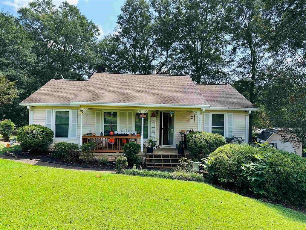 365 Scott Street Commerce, GA 30529 - Photo 1 of 1 a front view of a house with a garden and porch