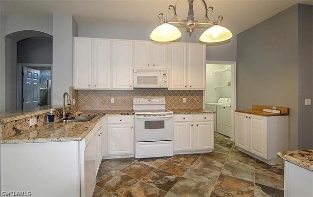 23351 Olde Meadowbrook Circle Estero, FL 34134 - Photo 11 of 25 a kitchen with a stove cabinets and sink
