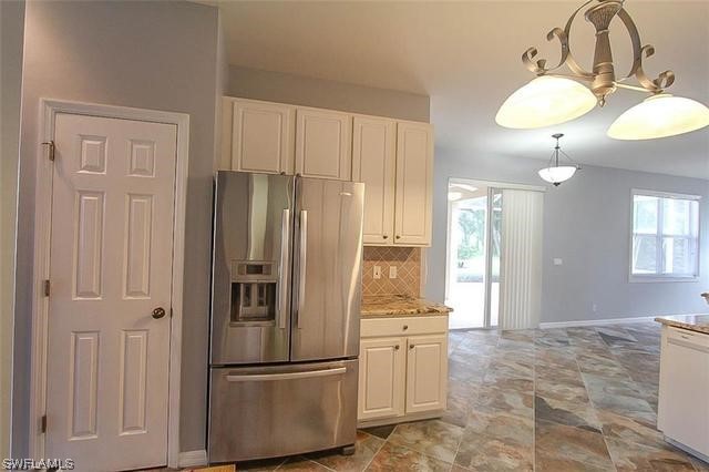 23351 Olde Meadowbrook Circle Estero, FL 34134 - Photo 13 of 25 a kitchen with stainless steel appliances granite countertop a refrigerator and a sink