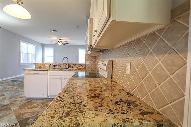 23351 Olde Meadowbrook Circle Estero, FL 34134 - Photo 14 of 25 a view of a kitchen with cabinets