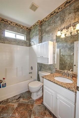 23351 Olde Meadowbrook Circle Estero, FL 34134 - Photo 17 of 25 a bathroom with a sink and a mirror