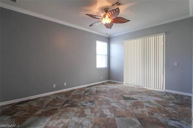 23351 Olde Meadowbrook Circle Estero, FL 34134 - Photo 21 of 25 an empty room with windows and chandelier fan