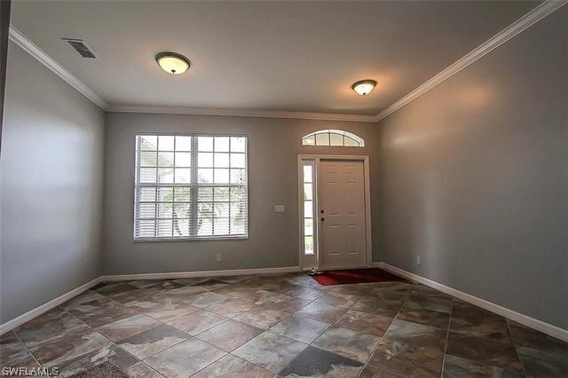 23351 Olde Meadowbrook Circle Estero, FL 34134 - Photo 7 of 25 an empty room with windows
