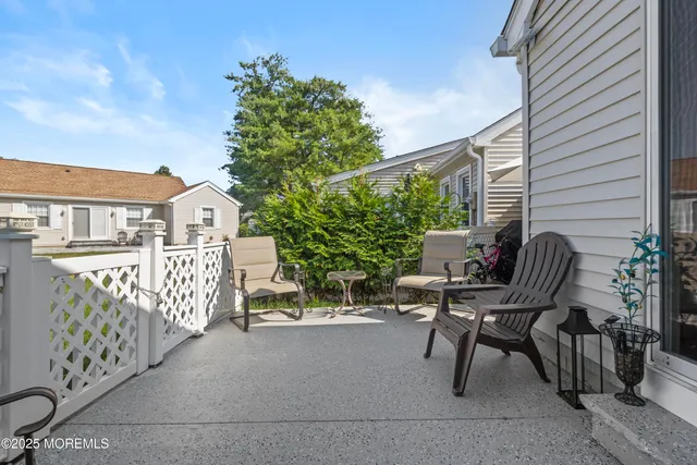 a view of a balcony with wooden floor and fence