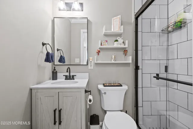 a bathroom with a sink a toilet and a mirror