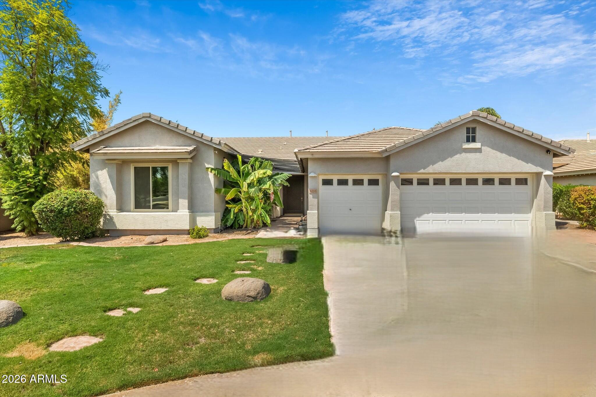 4018 East Harrison Street Gilbert, AZ 85295 - Photo 1 of 45 a front view of a house with garden