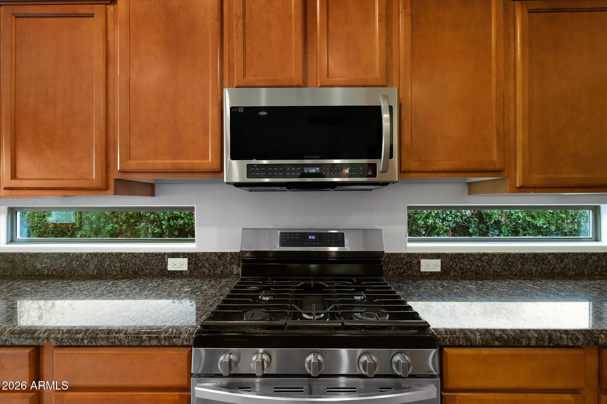 4018 East Harrison Street Gilbert, AZ 85295 - Photo 11 of 45 a kitchen with stainless steel appliances granite countertop a stove and a microwave