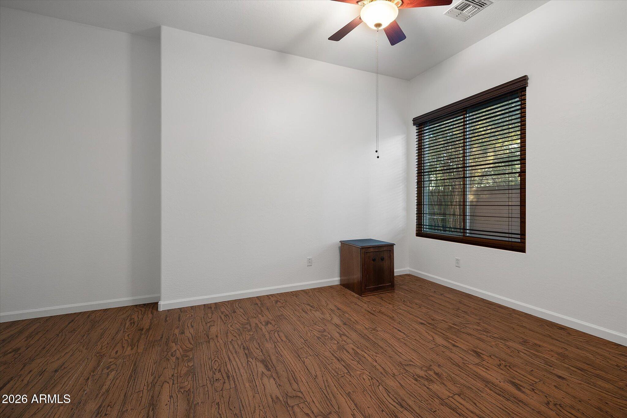 4018 East Harrison Street Gilbert, AZ 85295 - Photo 26 of 45 a view of an empty room with wooden floor and a window
