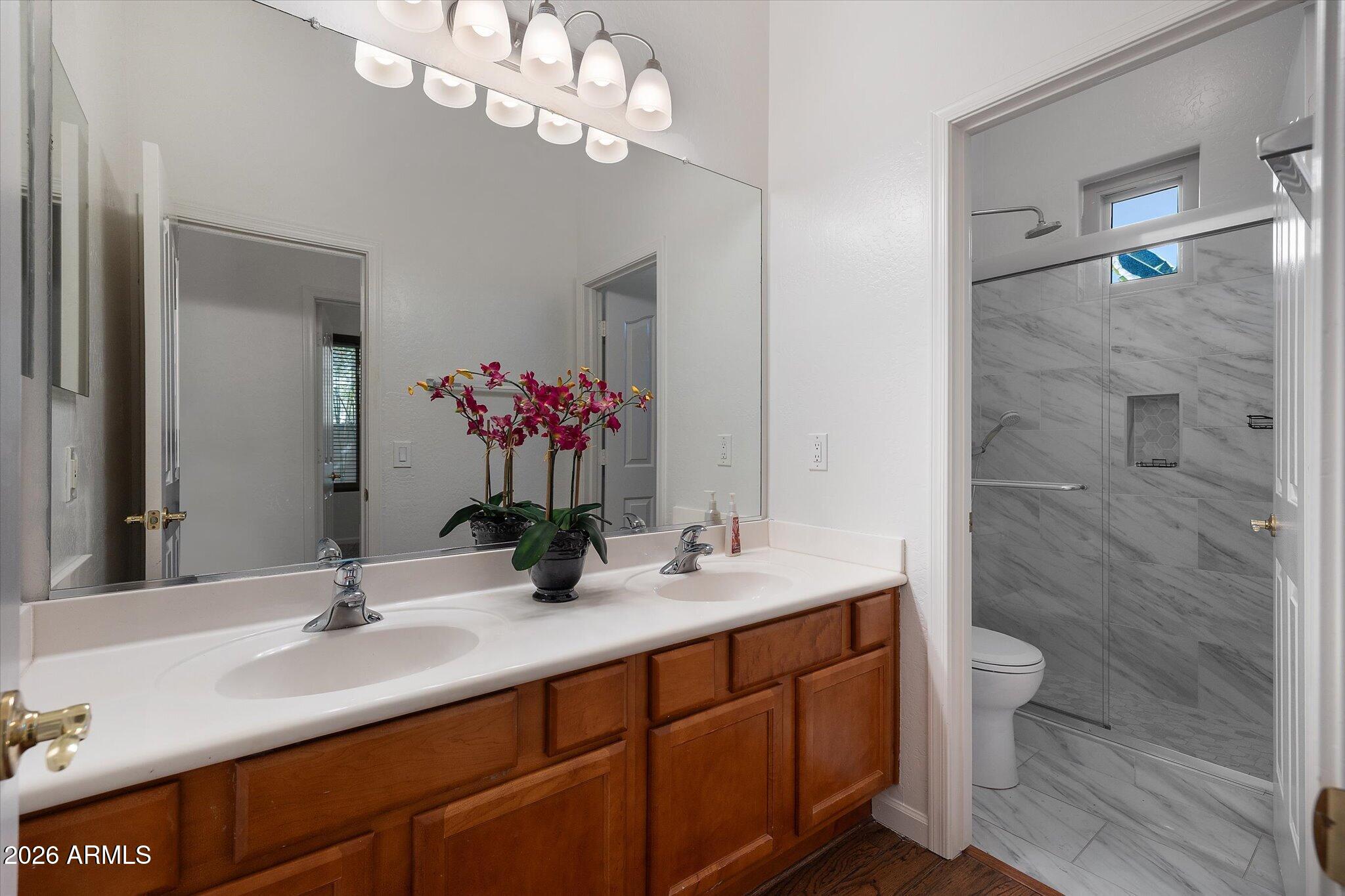 4018 East Harrison Street Gilbert, AZ 85295 - Photo 28 of 45 a bathroom with a double vanity sink mirror and toilet