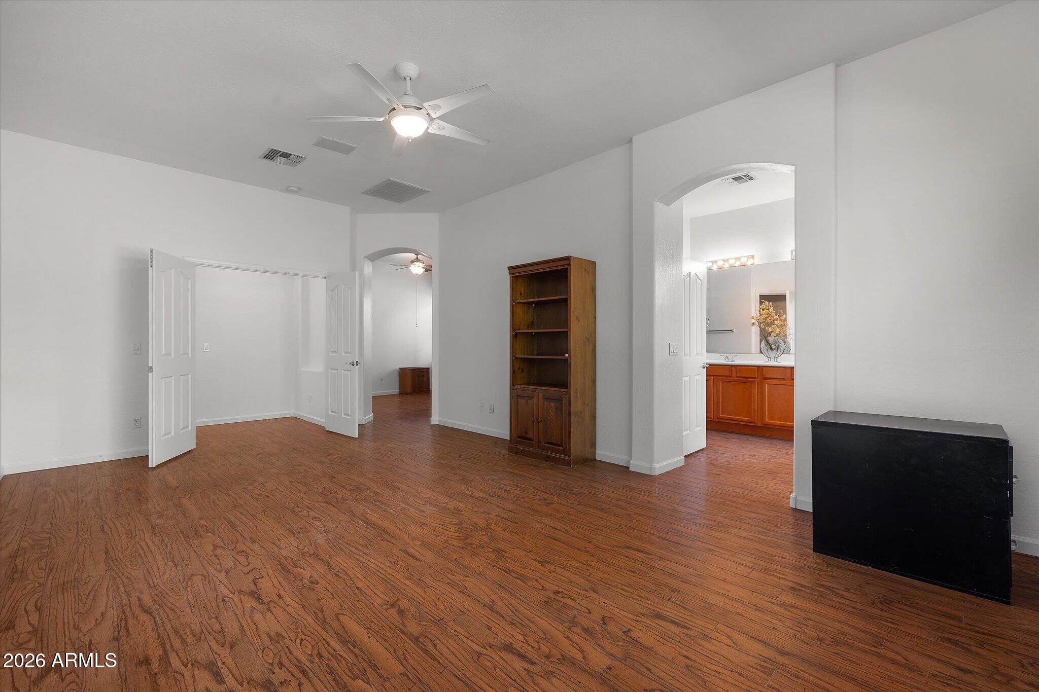 4018 East Harrison Street Gilbert, AZ 85295 - Photo 31 of 45 a view of an empty room with wooden floor and a ceiling fan