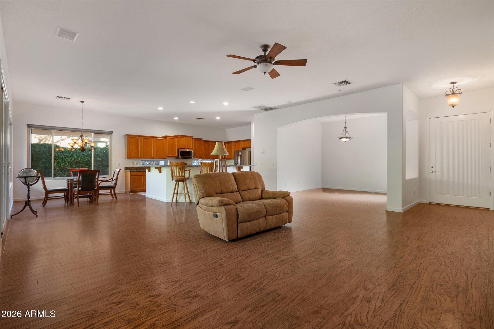 4018 East Harrison Street Gilbert, AZ 85295 - Photo 4 of 45 a living room with furniture and kitchen view with wooden floor