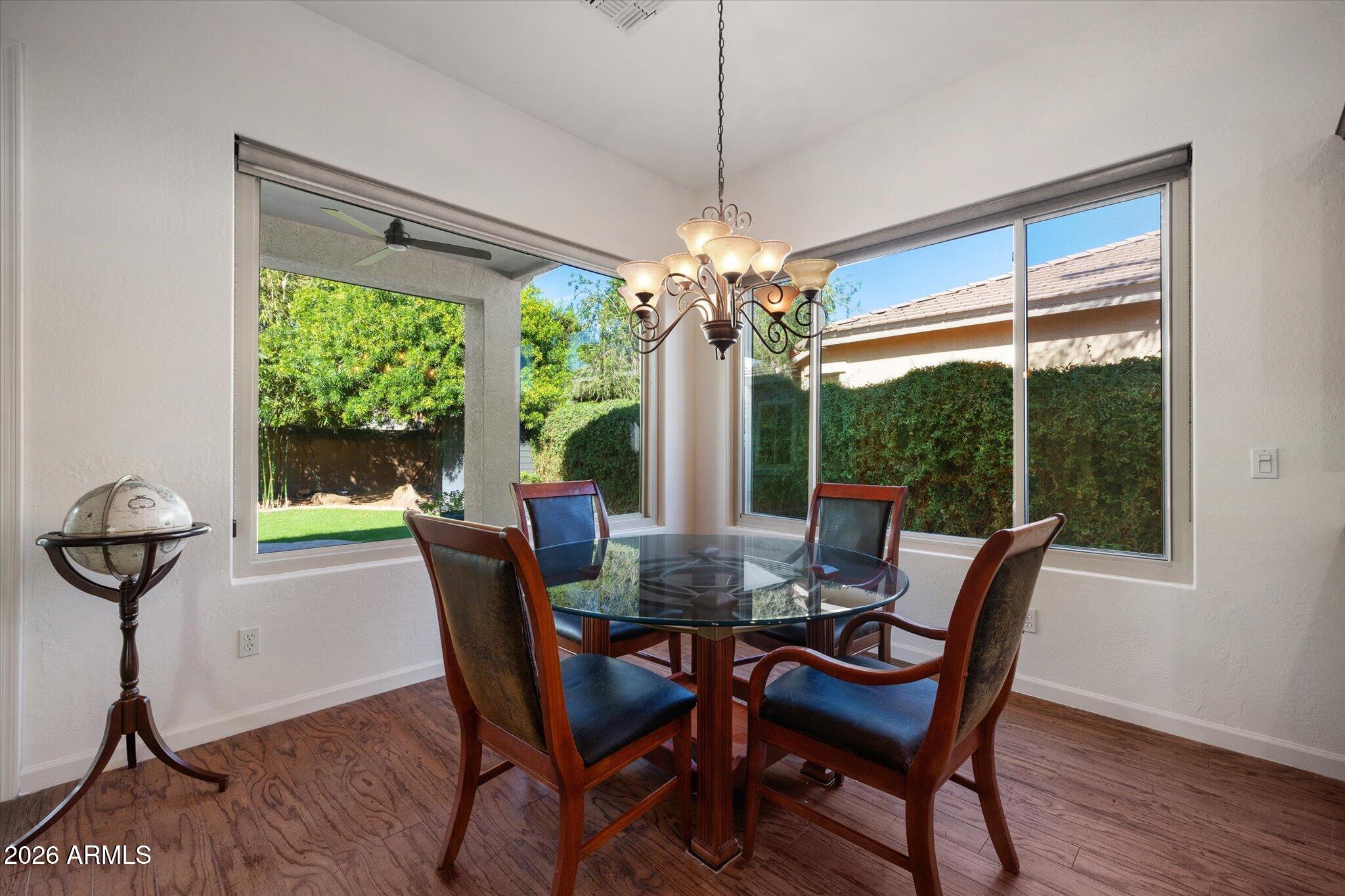 4018 East Harrison Street Gilbert, AZ 85295 - Photo 6 of 45 a dining room with furniture a chandelier and wooden floor