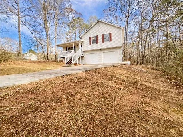 a view of a house with a yard covered in snow